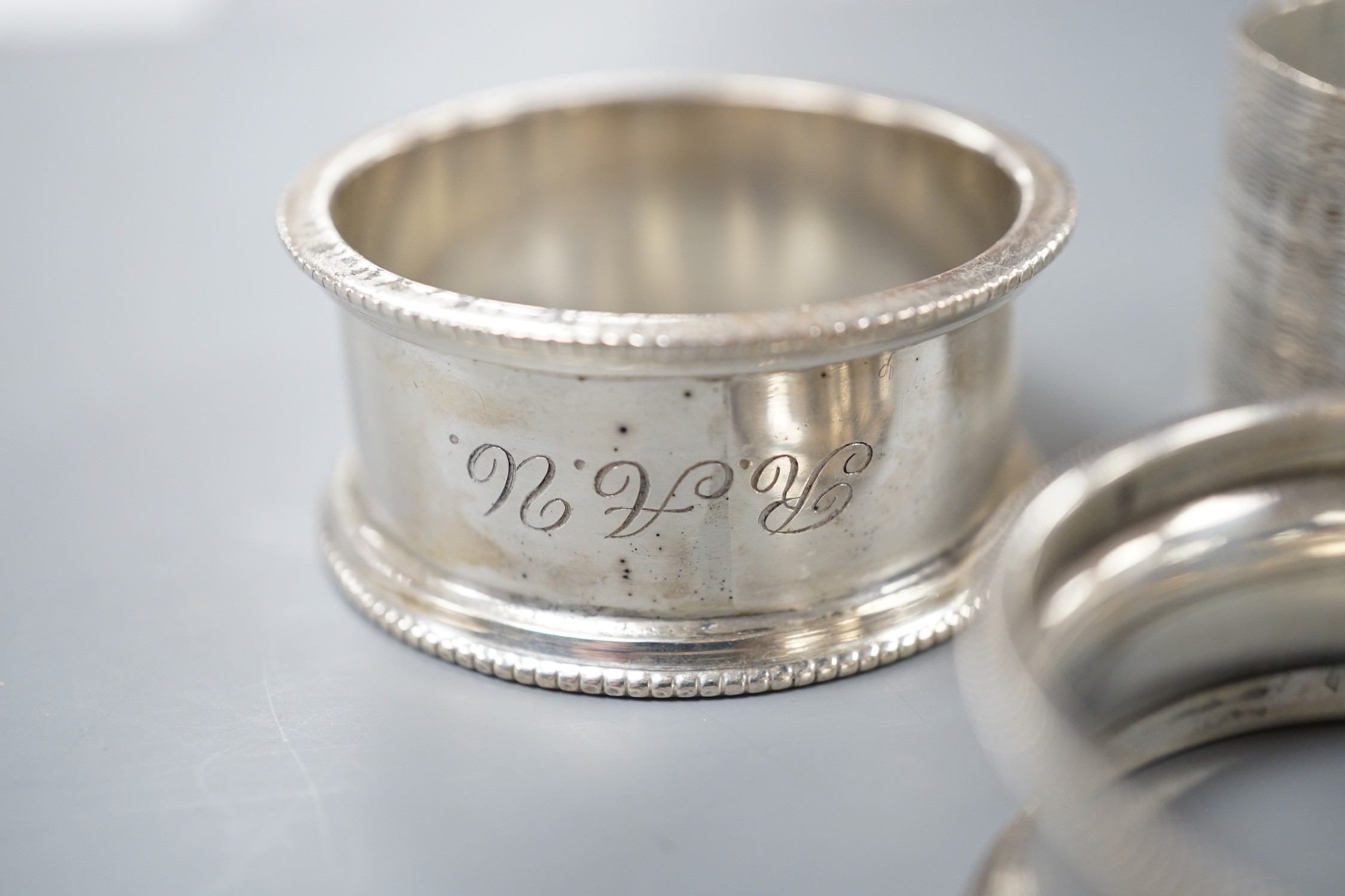 Seven assorted 20th century silver napkin rings, 121 grams.
